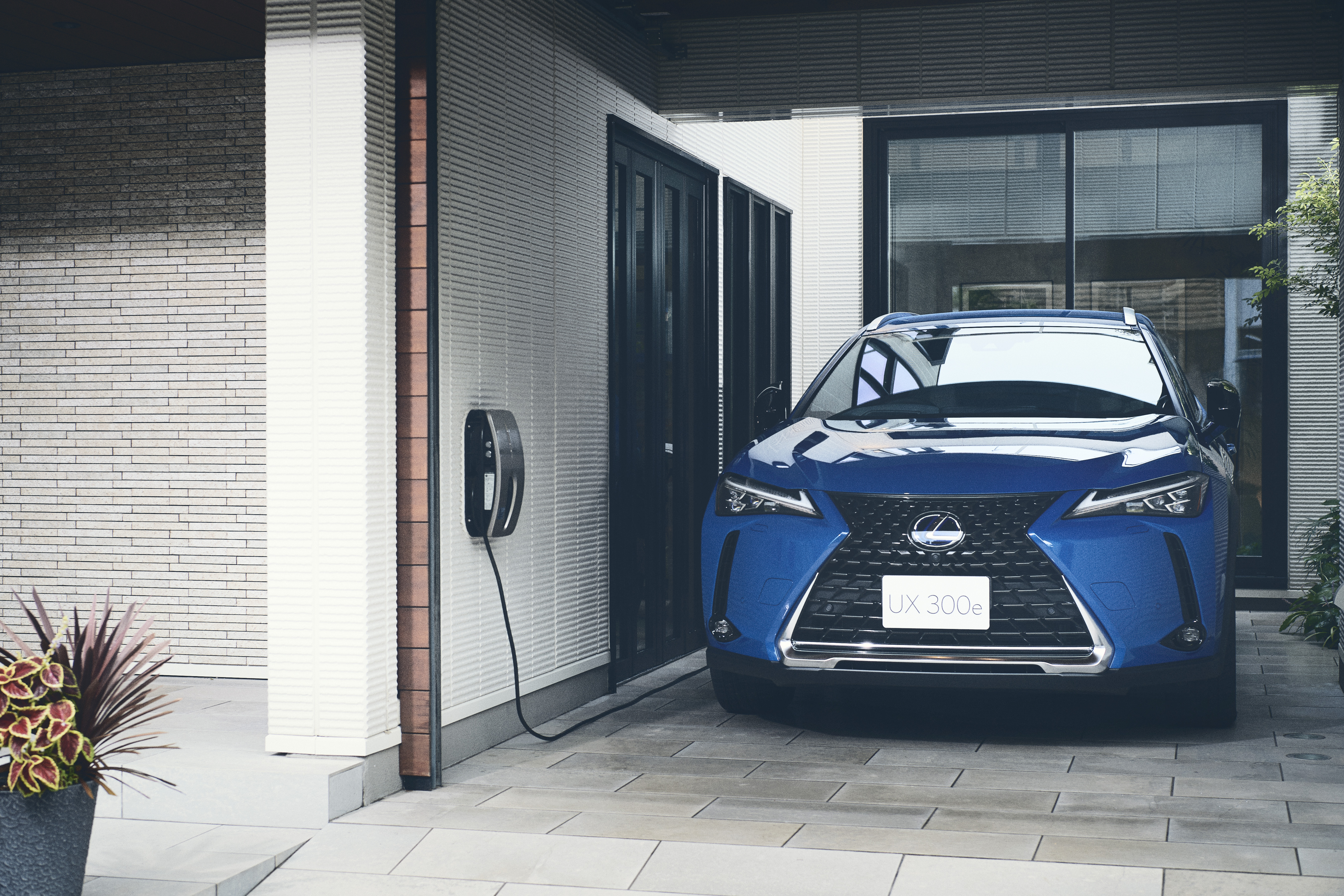 Silver Lexus UX being driven on the road.
