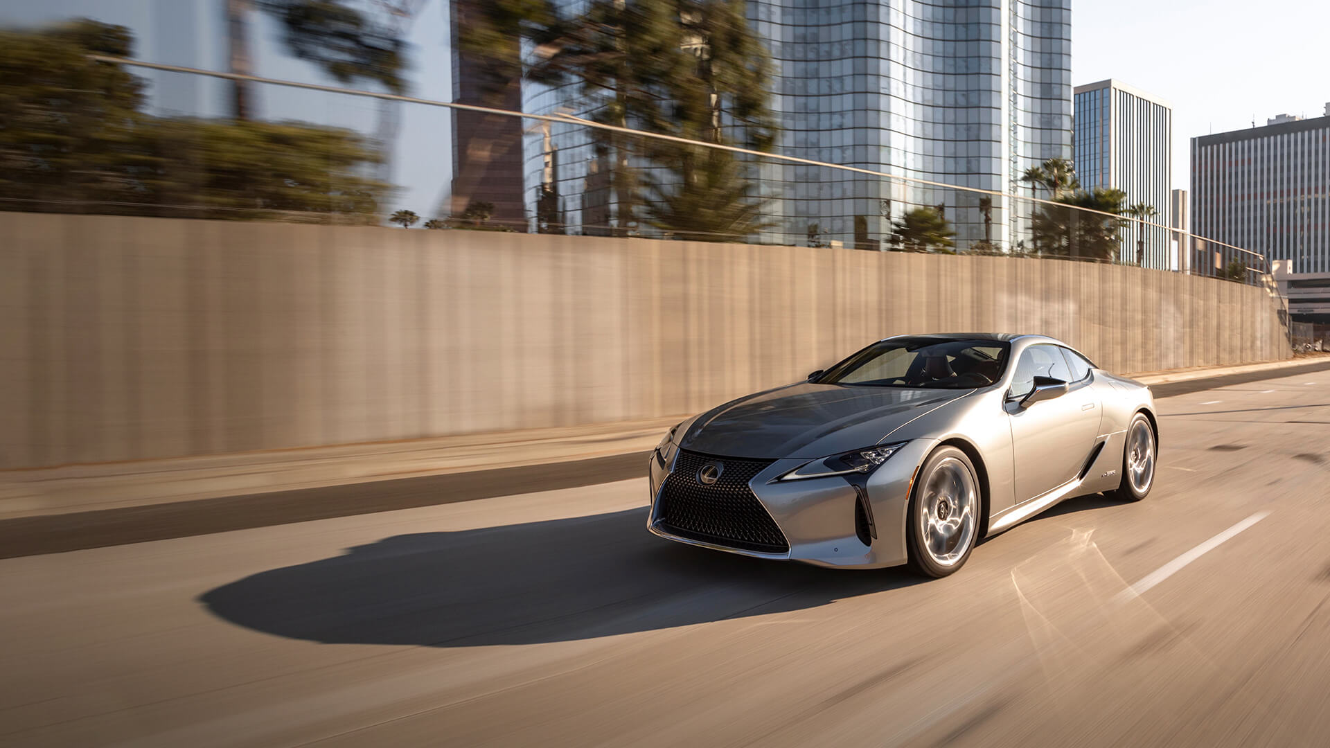 Silver Lexus LC 500 being driven on the road.