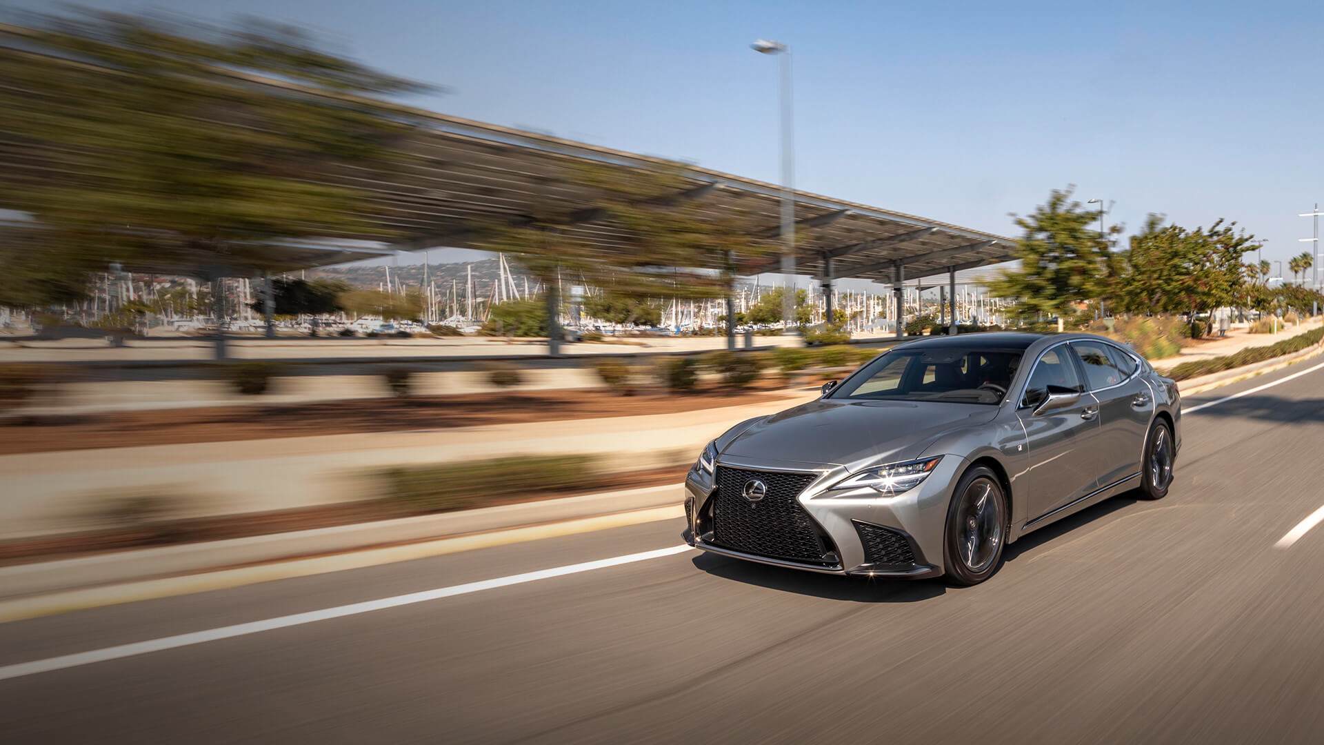 Silver Lexus LS being driven on the road.